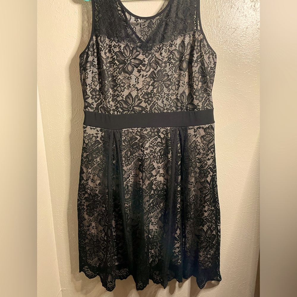 Black, lacy, sleeveless dress with a light nude attached slip